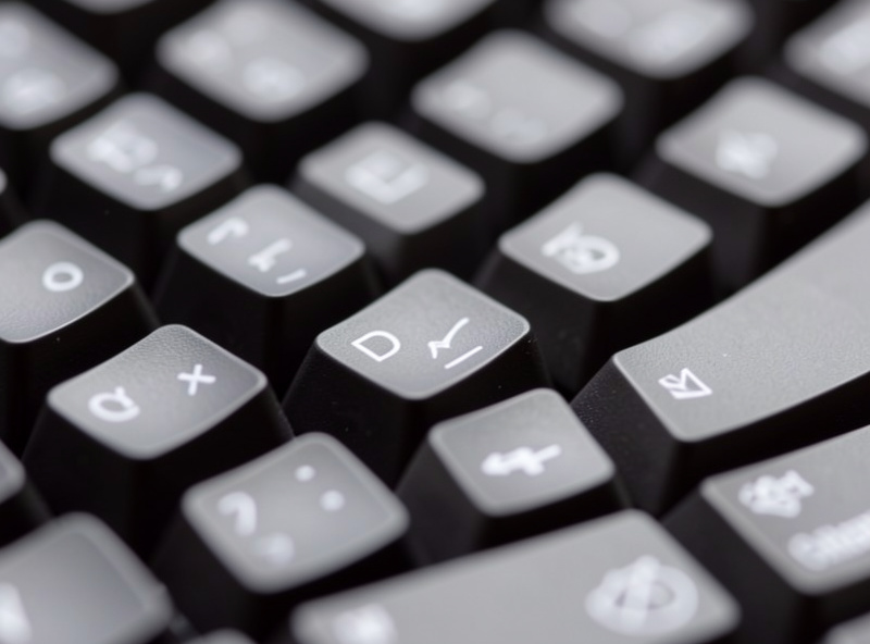 Close-up of programmable keyboard keycaps with symbol legends used for coding