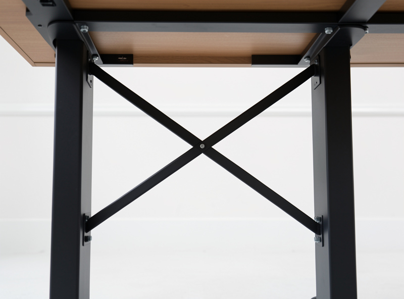 A crossbar bracing the lower section between two standing desk legs viewed from below